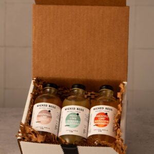 Wicked Bess Margarita shrub bundle — three 4oz artisan shrub bottles (Grapefruit Lime Ginger, Pear Lime Ginger Jalapeño, Pineapple Lime Mandarin Habanero) in a gift box
