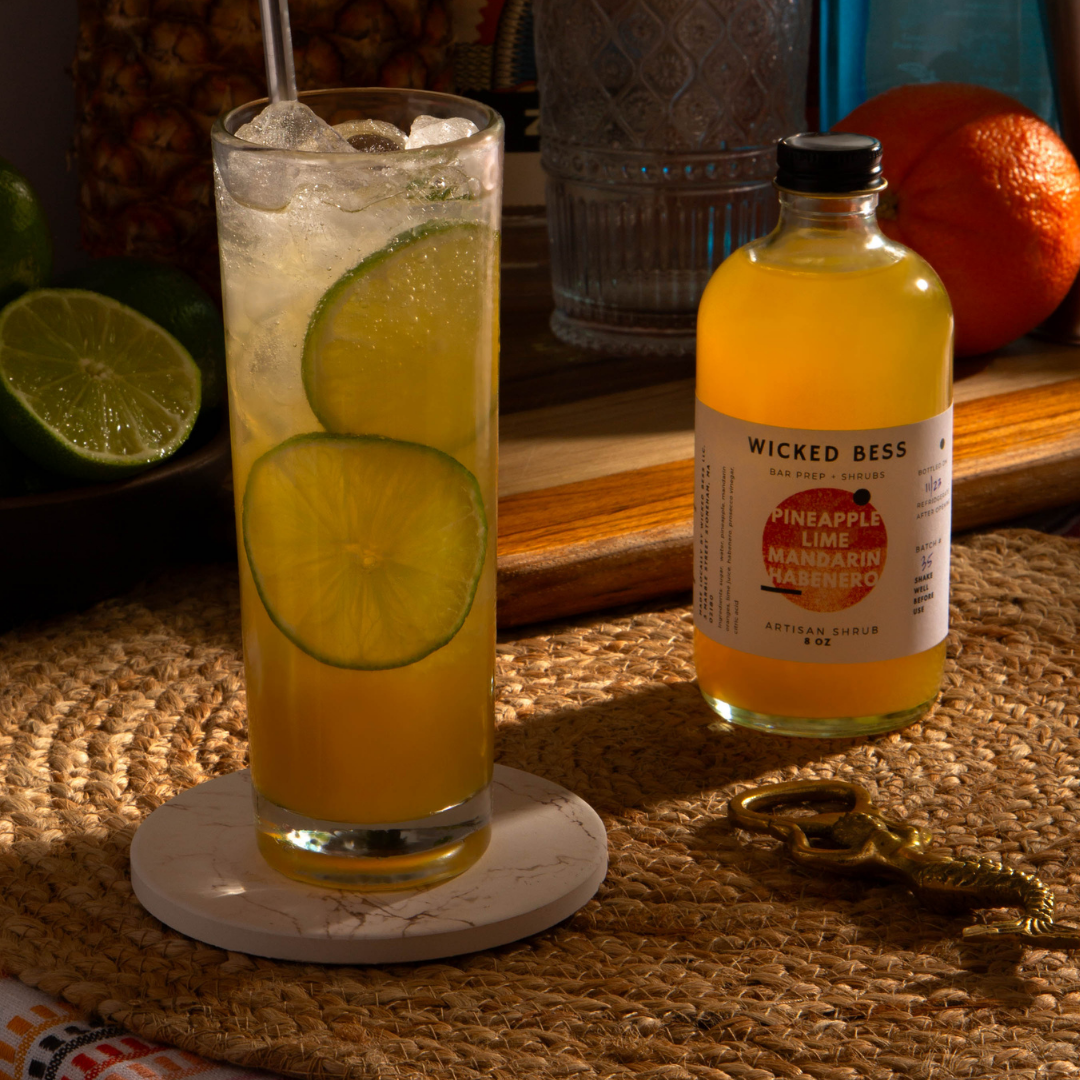 Still Life, Warm Heart cocktail with a bottle of Wicked Bess shrub