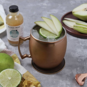Midnight in Paris cocktail with a bottle of Wicked Bess shrub