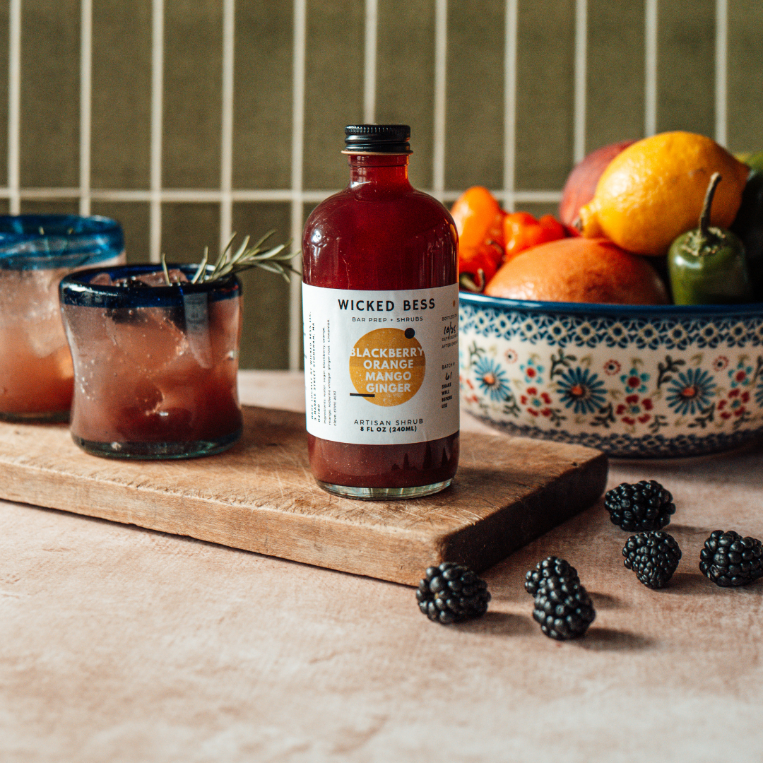 Phenomenal Woman cocktail with a bottle of Wicked Bess shrub