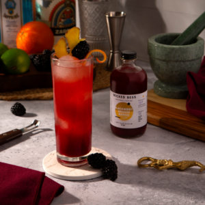 Heart of a Woman cocktail with a bottle of Wicked Bess shrub