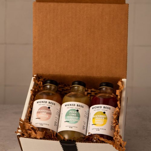 Wicked Bess Mule shrub bundle — three 4oz artisan shrub bottles (Grapefruit Lime Ginger, Pear Lime Ginger Jalapeño, Blackberry Orange Mango Ginger) in a gift box